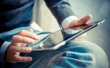 person holding tablet on lap