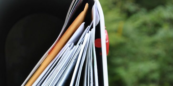 Go Paperless Program Hero mailbox stuffed with envelopes